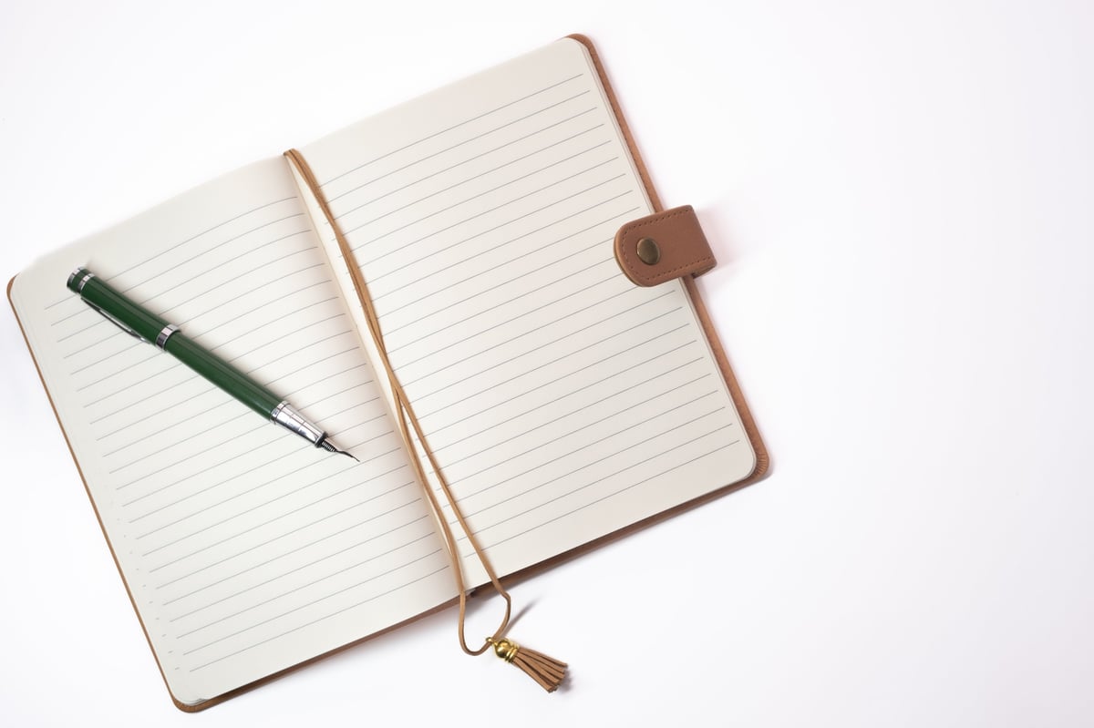 Open notebook with pen, ready for journaling and reflection